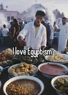 a man standing in front of a table full of food with the words i love egyptsm on it