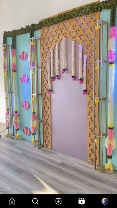 a room decorated with paper flowers and candles