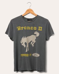 Women's Bronco Get Up and Go Vintage Tee | Junk Food Clothing Rugged Outdoor Relaxed Fit Top, Rugged Relaxed Fit Outdoor Top, Rugged Relaxed Fit Top For Outdoor, Vintage Adventure Graphic T-shirt, Vintage Graphic Print T-shirt For Adventure, Sporty Crew Neck Tops For Adventure, Vintage Crew Neck Tops For Adventure, Vintage Cotton T-shirt For Outdoor Activities, Vintage Short Sleeve T-shirt For Adventure