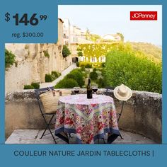 a table with a bottle of wine on top of it and an image of a castle in the background