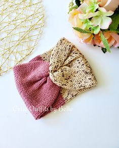 two knitted bow headbands sitting next to each other on a white surface