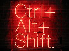 a red neon sign that says, girl at the shift on it's side