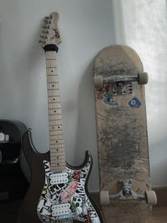 an electric guitar and skateboard are sitting next to each other