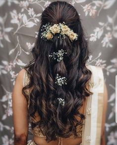 a woman with long hair and flowers in her hair