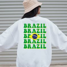 Brazil Themed Sweatshirt UNISEX *Size up for oversized look* Unisex heavy blend crewneck sweatshirt is pure comfort. Made from polyester and cotton. This combination helps to give a trendy and comfy look. The collar is ribbed knit, so it retains its shape even after washing. No itchy side seams. 50% cotton 50% polyester Medium-heavy fabric Loose fit Sewn-in label Runs true to size ... World cup 2022, qatar world cup, Brazil sweatshirt, Brazil crewneck, Brazil world cup, Brazil world cup shirt, B White Crew Neck Hoodie With Screen Print, White Crew Neck Hoodie With Slogan, White Crew Neck Sweatshirt With Slogan, White Slogan Crew Neck Hoodie, Brazil Zip Up, White Crew Neck Sweatshirt With Text Print, White Slogan Crew Neck Sweatshirt, Brazil Sweatshirt, Brazil Blue Jersey