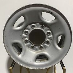 an old silver wheel with holes in the center