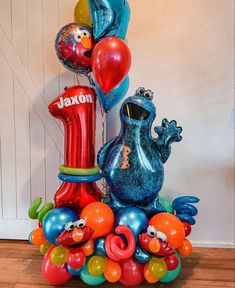 the balloon sculpture is made to look like sesame street characters