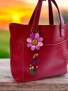 a red purse with a flower on it