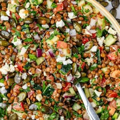 a salad with beans, cucumbers, and feta cheese in a bowl