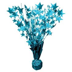 a vase filled with blue stars on top of a table