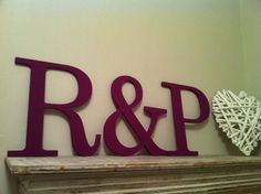 the letters r and p are on top of a fireplace mantel with a heart