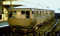 an old train car sitting on the tracks