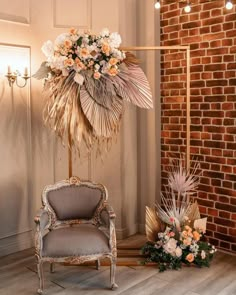 a chair with flowers on it in front of a brick wall and chandelier