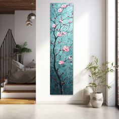 a painting hanging on the wall next to a plant in a room with white walls