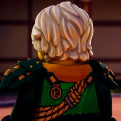 a close up of a lego figure wearing a green and yellow outfit with white hair