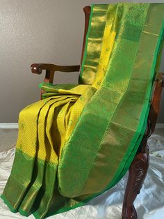 "Brocade turning border kanjeevaram blended silk saree in traditional lemon yellow and green combination.Body has thilagam motif with meenakari work .Lower border is intricately woven in floral pattern . A rich pallu completes the look. The fabric is not transparent , blended silk. Comes with stitched blouse with hand embroidery work. falls and pico and tassels done. Details: Colour:              Yellow Pattern:              brocade Blouse Colour: Green Blouse Size:      36\" margin till 40\" in Yellow With Green Silk Saree, Semi-stitched Yellow Slub Silk Saree, Unstitched Yellow Raw Silk Saree, Semi-stitched Slub Silk Yellow Saree, Yellow Saree Green Border, Blouse Colour, Green Combination, Hand Embroidery Work, Brocade Blouse