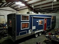 a blue and silver trailer parked in a garage