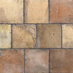 a brick wall with several different colored bricks on the bottom and one side that is brown