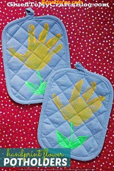 two pot holders with hand prints on them