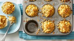 some muffins are sitting on a plate and next to a cupcake tin