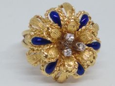 Vintage 18K, yellow gold, floral motif ring. The petals have a cobalt blue enamel with the center accented with 3 small diamonds.  The top measures 23.3 x 21.3 and sits, approximately, 15 mm high. The ring is a size 7.5 and is 7.7 Pennyweights. Shipped Register Mail Only. Gold Floral, Vintage Yellow, The Ring, Floral Motif, Cobalt Blue, Cobalt, Jewelry Watches, Jewelry Rings, Fine Jewelry