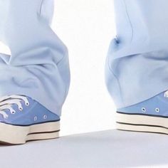 a pair of blue shoes with white laces