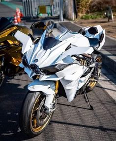 two motorcycles parked next to each other on the street