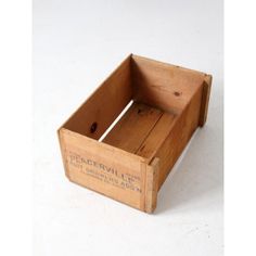 an old wooden box that has been used as a storage container for wine or other items