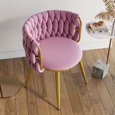 a pink chair sitting on top of a wooden floor