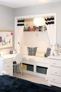 a bedroom with a bed, desk and window in the corner next to a dresser