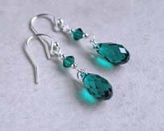 "Emerald green crystal teardrop earrings are made with emerald crystal teardrops accented with silver or gold beads.  They dangle 1\"  from sterling silver or gold fill ear wires. Emerald is the birth crystal color for May.  ❖  Crystal Passions crystals ❖  silver or gold fill beads ❖  .925 sterling silver or 14k gold fill ear wires Earrings shown are on french hook ear wires.  All earring types are sterling silver or gold fill with the exception of clip-ons, which are silver or gold plated. Hypoallergenic french hooks are stainless steel." Green Sterling Silver Teardrop Earrings Hypoallergenic, Teardrop Green Crystal Earrings, May Birthstone Teardrop Earrings, Green Teardrop Birthstone Earrings, Briolette Jewelry, Craft Earrings, Briolette Earrings, Emerald Green Crystal, Wire Jewelry Rings