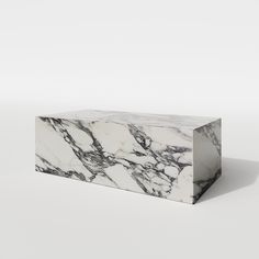 a white and black marble box sitting on top of a table