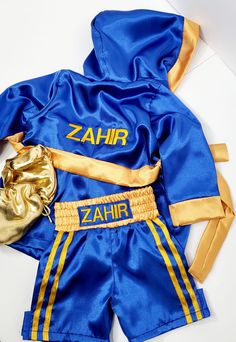 Do you have a little fighter at home? This Personalized Boxing set with shorts, robe and wearable baby gloves is perfect for a 1st birthday photoshoot or even an idea for kids photoshoot. We offer them in any color, size and personalization. Come check our 45% off Black Friday sale.