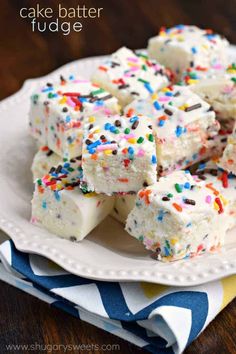 chocolate cupcakes with white frosting and sprinkles are on a plate