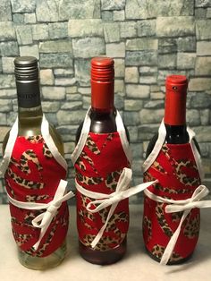 three wine bottles wrapped in red and leopard print