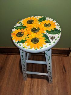 a painted stool with sunflowers on it