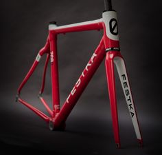 a red bike frame with white and black lettering on it