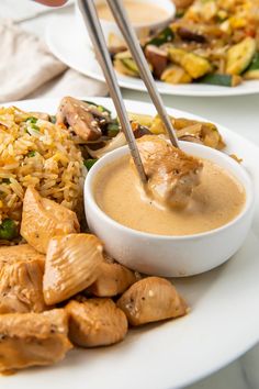 a white plate topped with chicken and rice