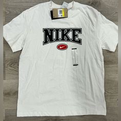 Brand New Nike T-Shirt! Nike Cotton T-shirt For Streetwear, Basic White T-shirt With Logo, Basic White Logo T-shirt, Nike Graphic Tee With Letter Print, Nike Graphic Tee With Text Print, Nike T-shirt With Text Print And Crew Neck, Nike Cotton Top With Logo, Nike Cotton Tops With Logo, Basic White Logo Tops