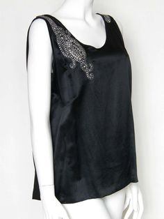 For Sale on 1stDibs - Elegant black sleeveless evening blouse with a deep 'swag' of stud set rhinestones down the back. The rhinestones start on the left shoulder, run down Black Vintage Evening Top, Vintage Black Evening Top, Black V-neck Tops With Rhinestones, Fitted Black Embellished T-shirt, 1940s Clothing, Black Satin Button-up Blouse, Fitted Party Dress, 1970s Blouse, Black Silk Blouse