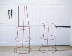 two red wire stands in front of a garage door