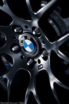 the wheel and tire of a car with bmw logo on it's center piece