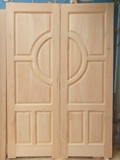 two wooden doors in the process of being built