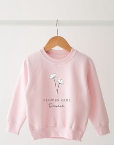 This gorgeous sweatshirt is definitely a wardrobe essential. The perfect gift for your flower girls . Finished with a gorgeous white flower.  Choice of Lilac or pink. Spring Gift Long Sleeve Sweatshirt, Spring Long Sleeve Sweatshirt, Flower Girl Gifts, Girl Sweatshirts, Flower Girls, Personalised Kids, Kids Sweatshirt, White Sweatshirt, White Flower