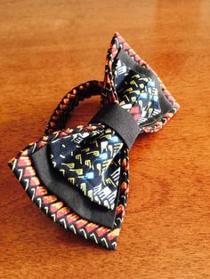 "A three-layered men's bowtie made with multicolored African fabric. This bowtie measures 5\" 3\". The strap, which is adjustable is made with standard 3-piece hook and eye slider bowtie hardware and is the same fabric as the bowtie. The strap goes up to 18\" If you have questions or want more information about this savvy bowtie or bulk ordering for any event, please feel free to make contact and we'll be happy to help! Dry clean only. Please note that there may be factors that could affect the Unique Bow Tie, Mens Bowtie, Tie For Women, Groomsmen Ties, Bow Tie Wedding, Mens Bow Ties, African Fabric, Different Patterns, Gifts Photos