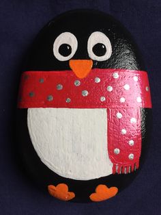 a painted rock with a penguin on it