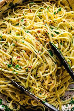 a large bowl filled with pasta and topped with parmesan sprinkles