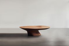 a wooden table sitting on top of a gray floor