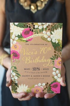 a woman holding up a card with flowers on it and the words sweet as birthday written in gold