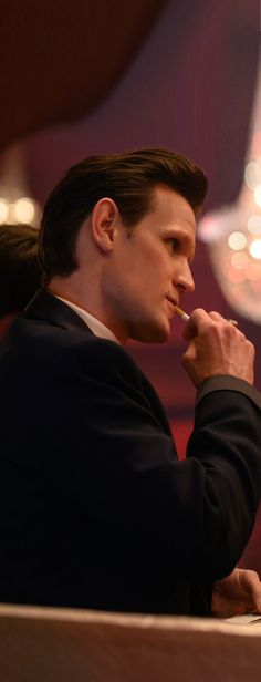 a man in a suit sitting at a table